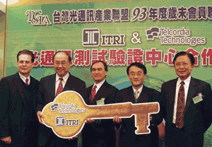 《圖一 Telcordia資深副總M. Duane Elmguist(中)將象徵測試驗證的Key轉交給光電所所長劉容生(左二)和電通所鄭勝慶組長(右二),由工業局工合小組徐明主任(右一)及Devco副總裁James Gzrella(左一)共同見證。》