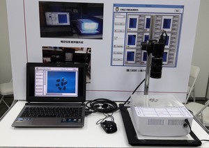 高雄科技大學電子工程系邱建良副教授研發的生物晶片影像辨識技術,目前可辨識最小條碼線寬達0.08mm。(攝影/陳復霞)